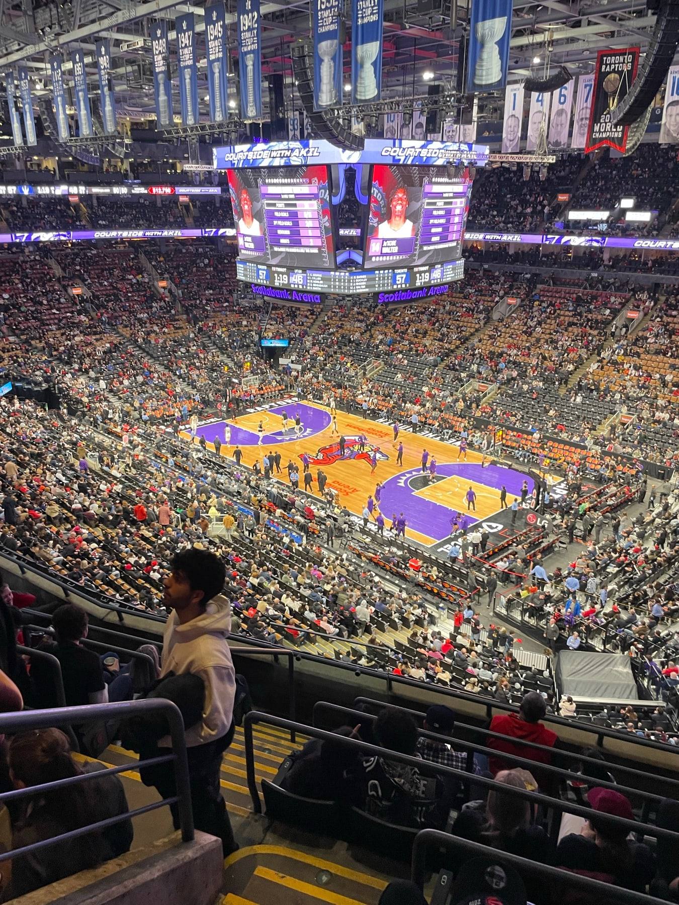 A packed basketball arena seen from the upper tier during a Raptors game.