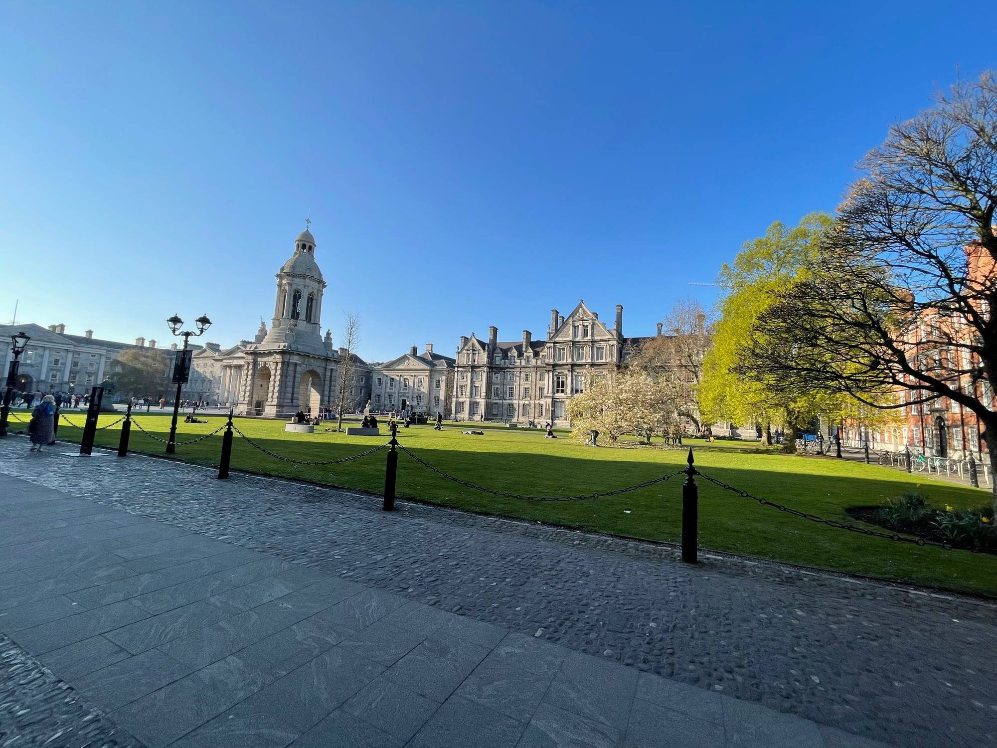 Front Square at Trinity College Dublin on a bright spring day, the campanile and lawns in sunlight.